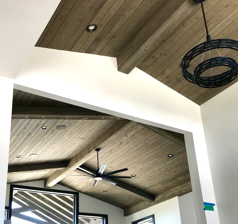 Rustic stained wood ceiling with beams