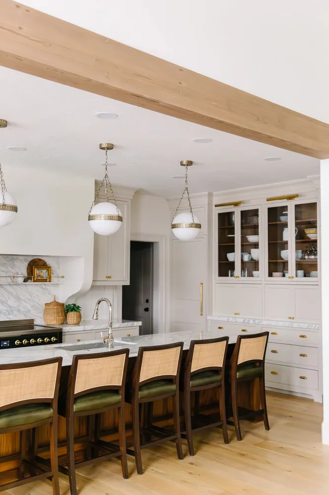 Kitchen island beneath a wood beam