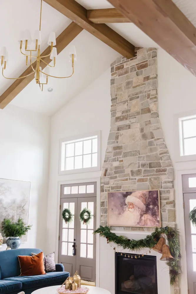 Tall stone fireplace with timber beams above