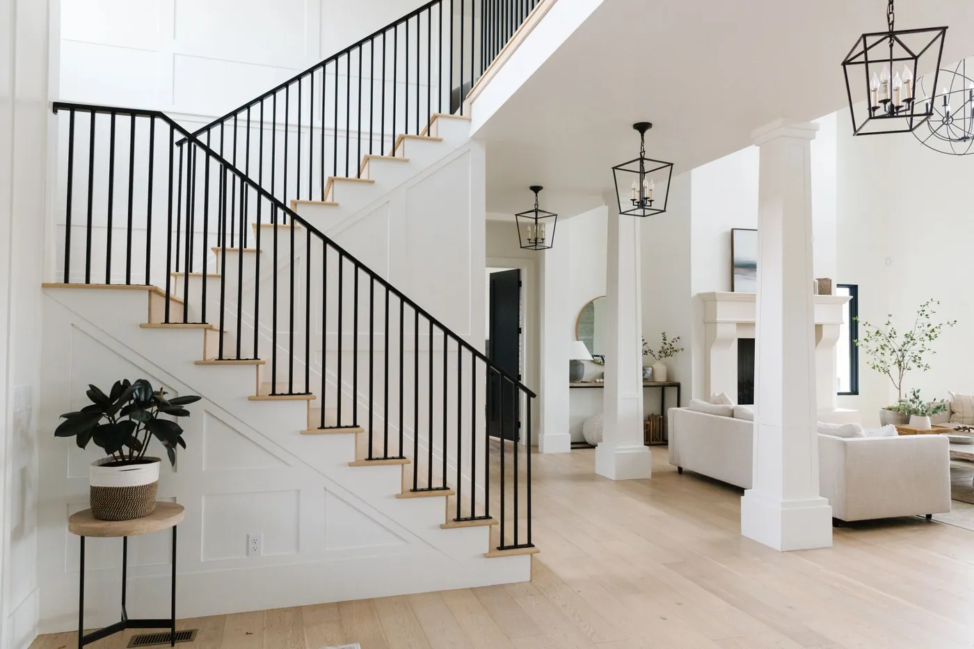Staircase with black iron railing and wood treads