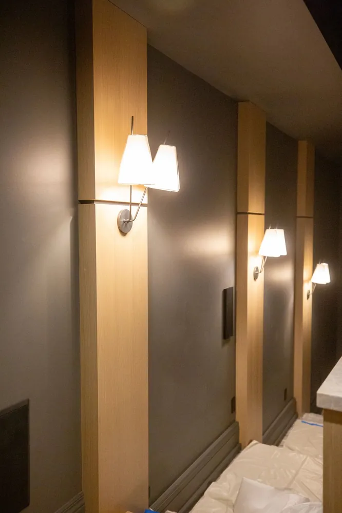 Wood-trimmed wall with sconces