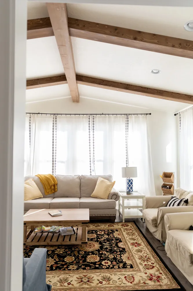 Sitting room with dark beams and a vaulted ceiling
