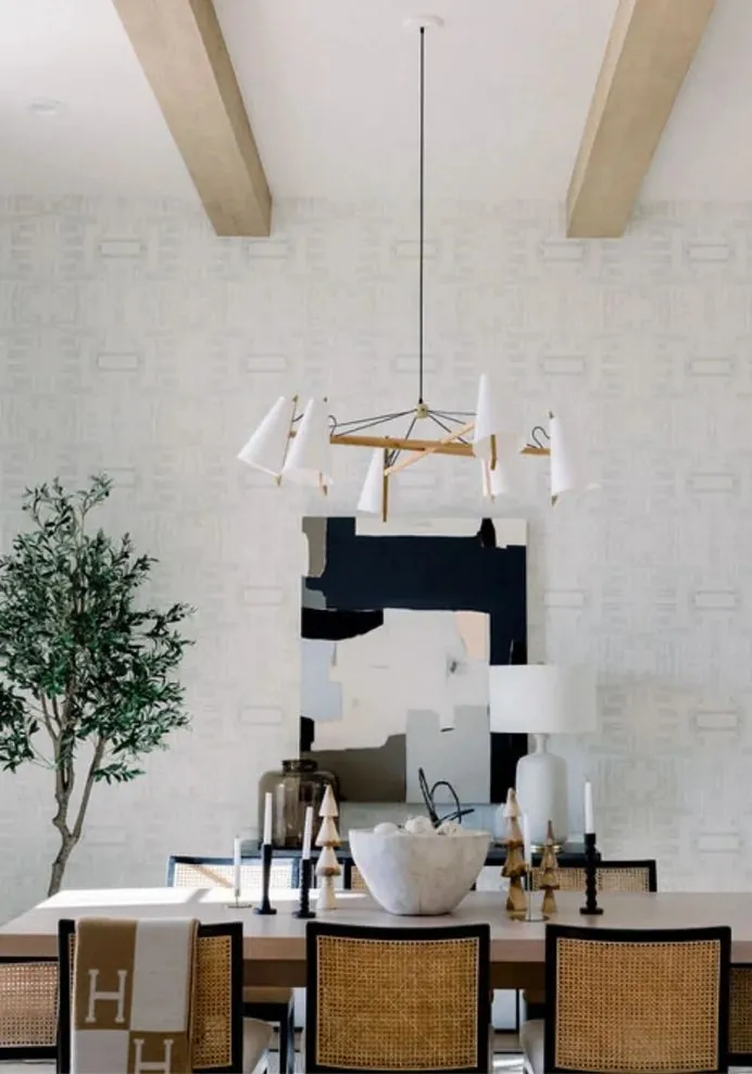 Dining room with ceiling beams and chandelier